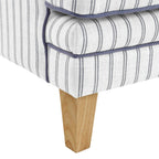 Anchorage Lounge Chair in Newport Stripe fabric with blue piping and light wood legs.