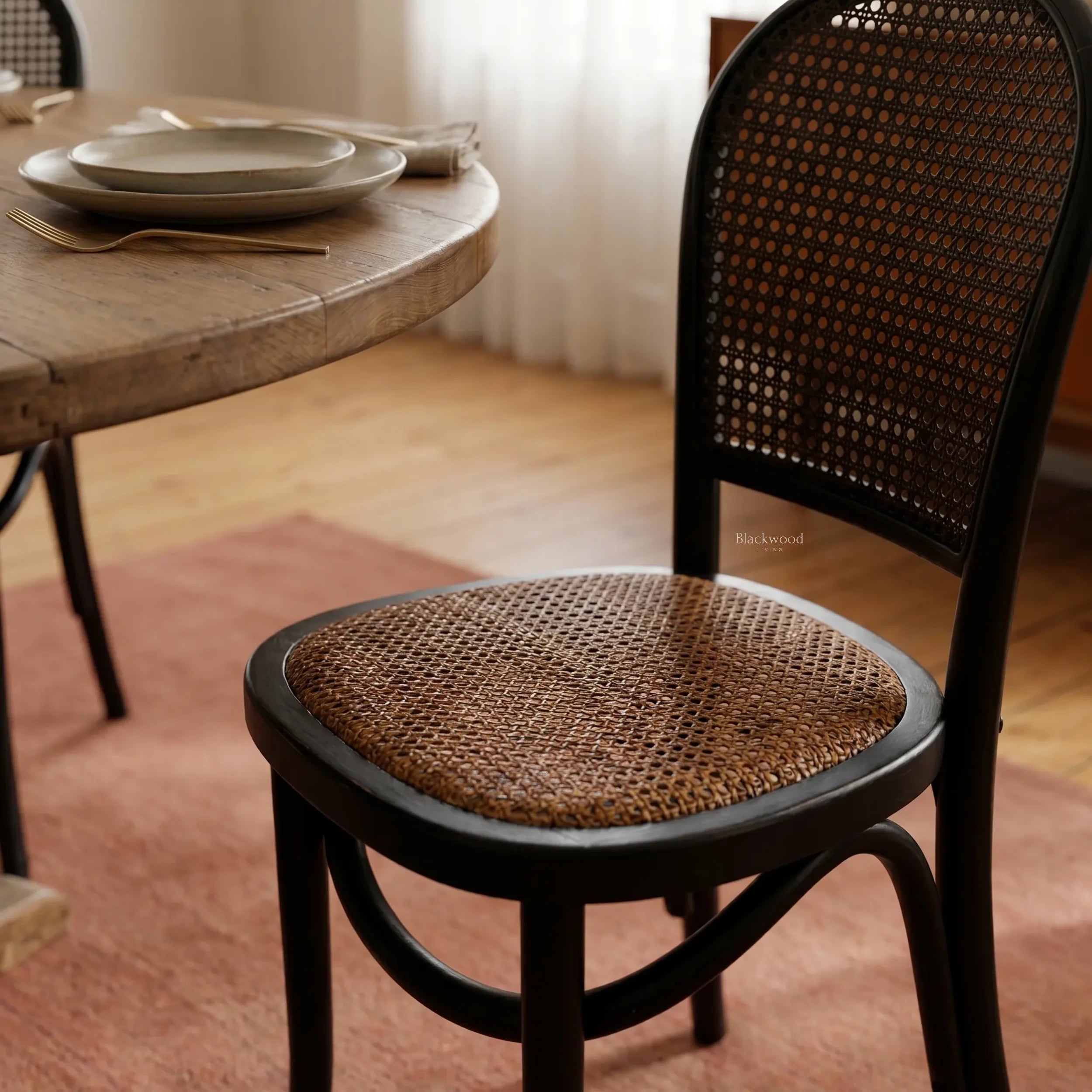 Langford Oak Bistro Chair with solid oak frame, hand-finished rattan back, and cushioned woven seat.