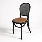 Langford Oak Bistro Chair with solid oak, hand-finished rattan back, and cushioned woven seat.