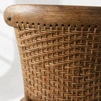 Close-up of Willowmere Oak Dining Chair showing handwoven rattan detail in warm antique oak.