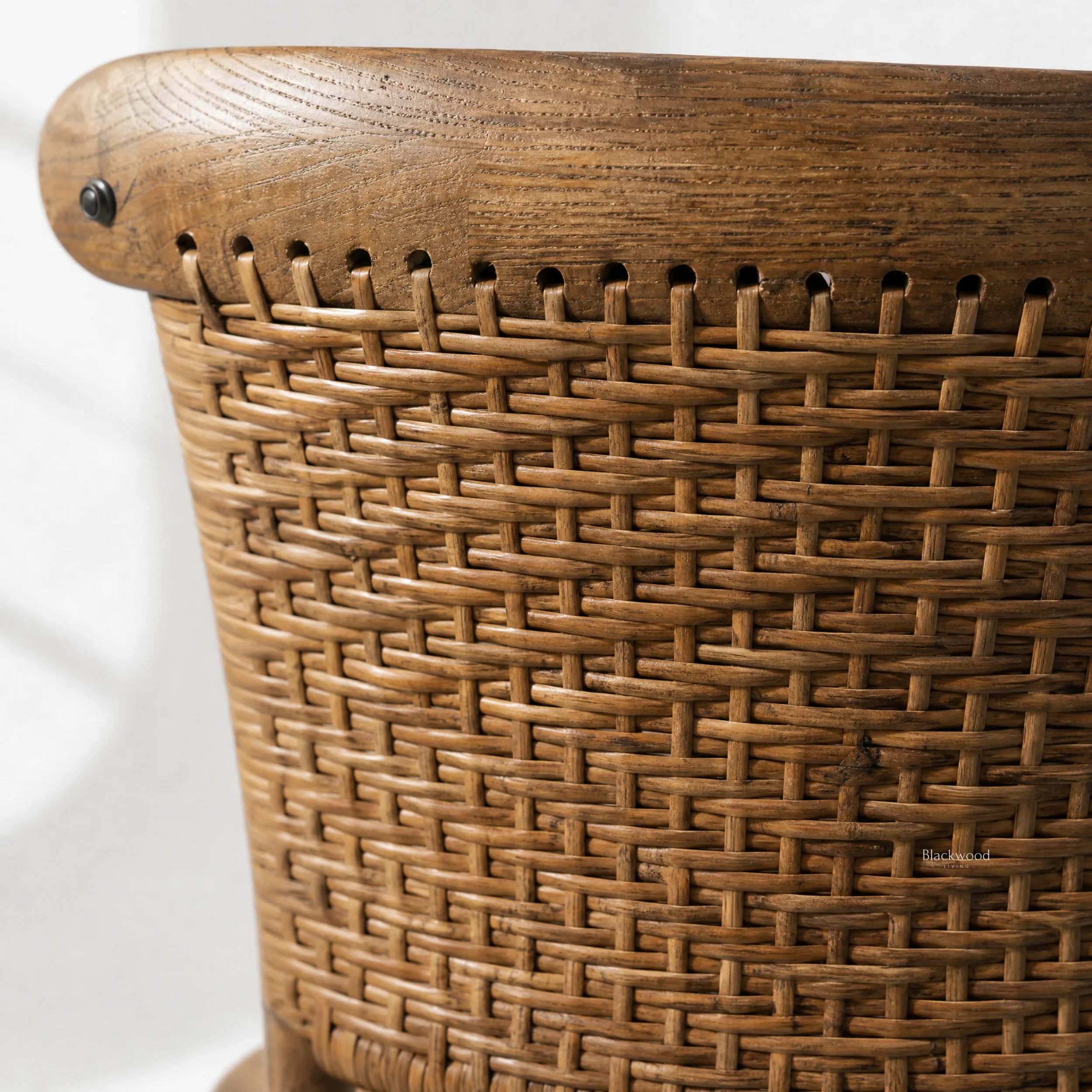 Close-up of Willowmere Oak Dining Chair showing handwoven rattan detail in warm antique oak.