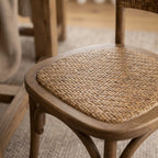 Willowmere Oak Dining Chair with handwoven rattan seat and warm antique oak frame.