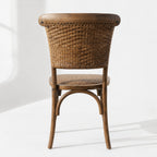 Willowmere Oak Dining Chair with antique oak frame and handwoven rattan detailing, farmhouse charm.