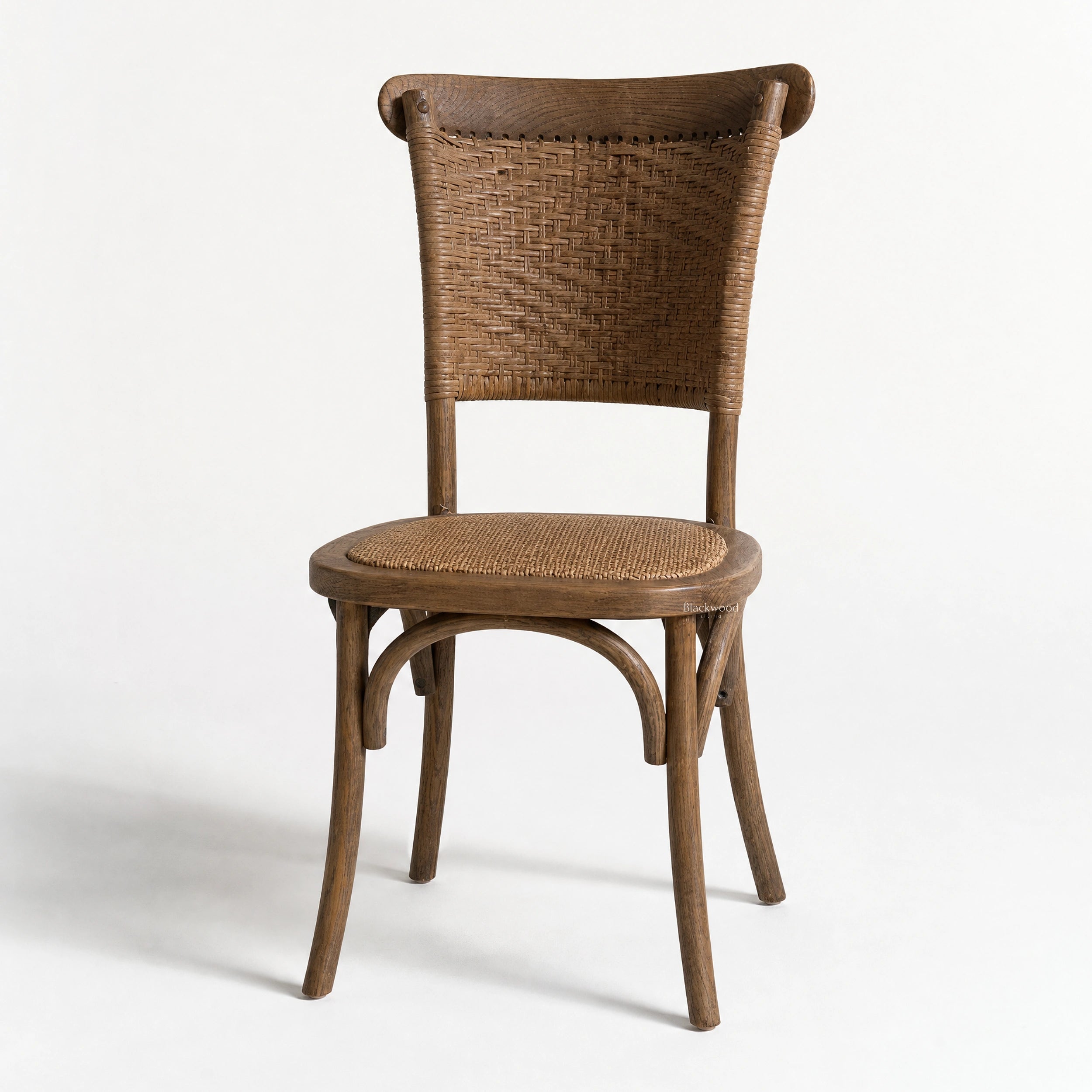 Willowmere Oak Dining Chair with handwoven rattan back and seat in warm antique oak finish.