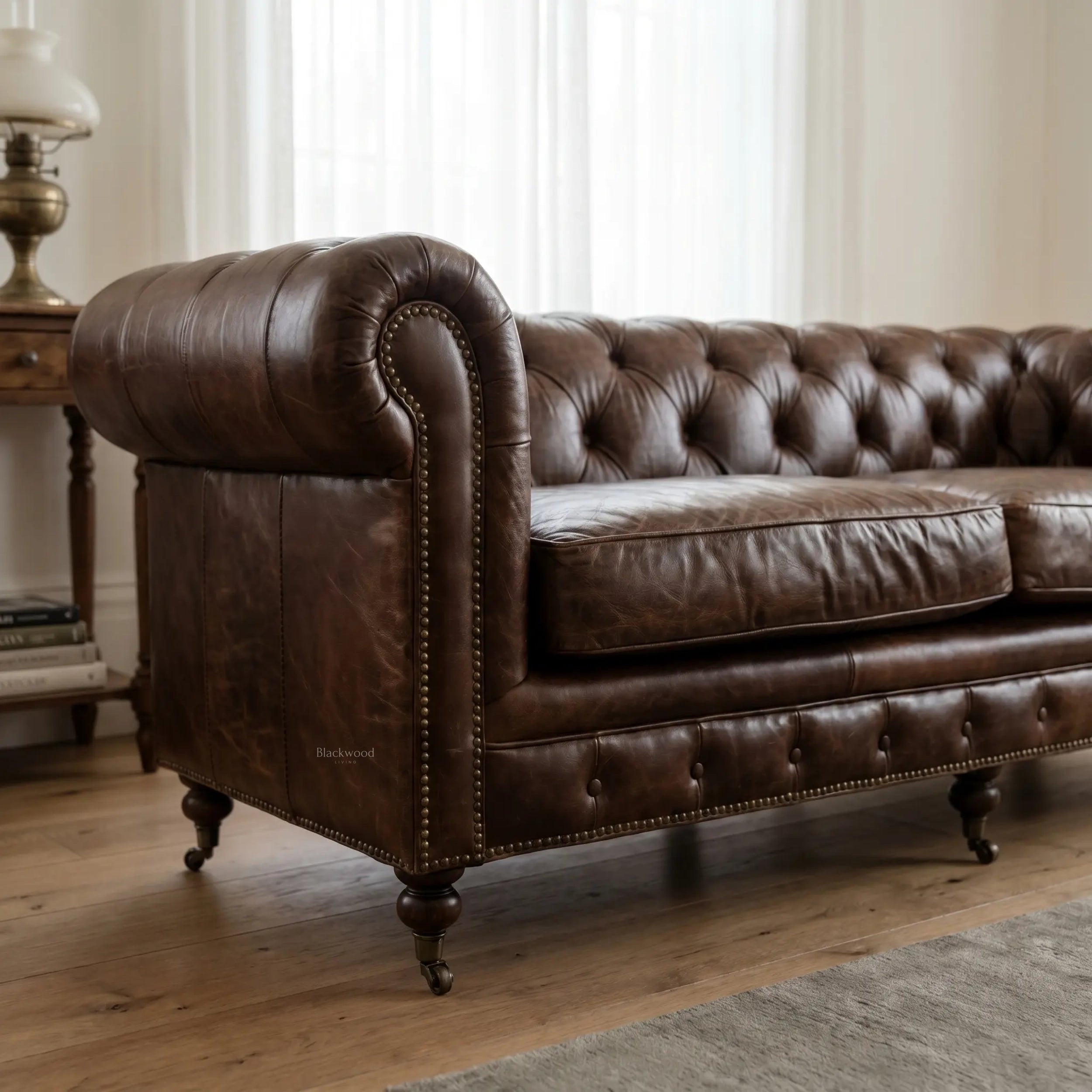 Ashcroft Sofa - Three Seat in top grain cow leather with deep buttoned Chesterfield and rolled arms with brass studs.