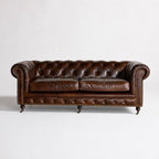 Ashcroft Sofa Three Seat in South American top-grain leather with deep buttoned Chesterfield brass studs, rolled arms.