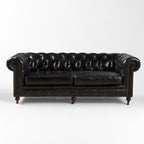 Ashcroft Sofa - Three Seat in black topgrain cow leather, deep buttoned Chesterfield, rolled arms, brass studs.