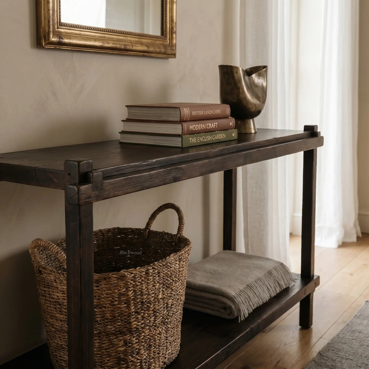 Millhouse Console in Antique Walnut solid fir, farmhouse-style entryway table with books and a metal vase.