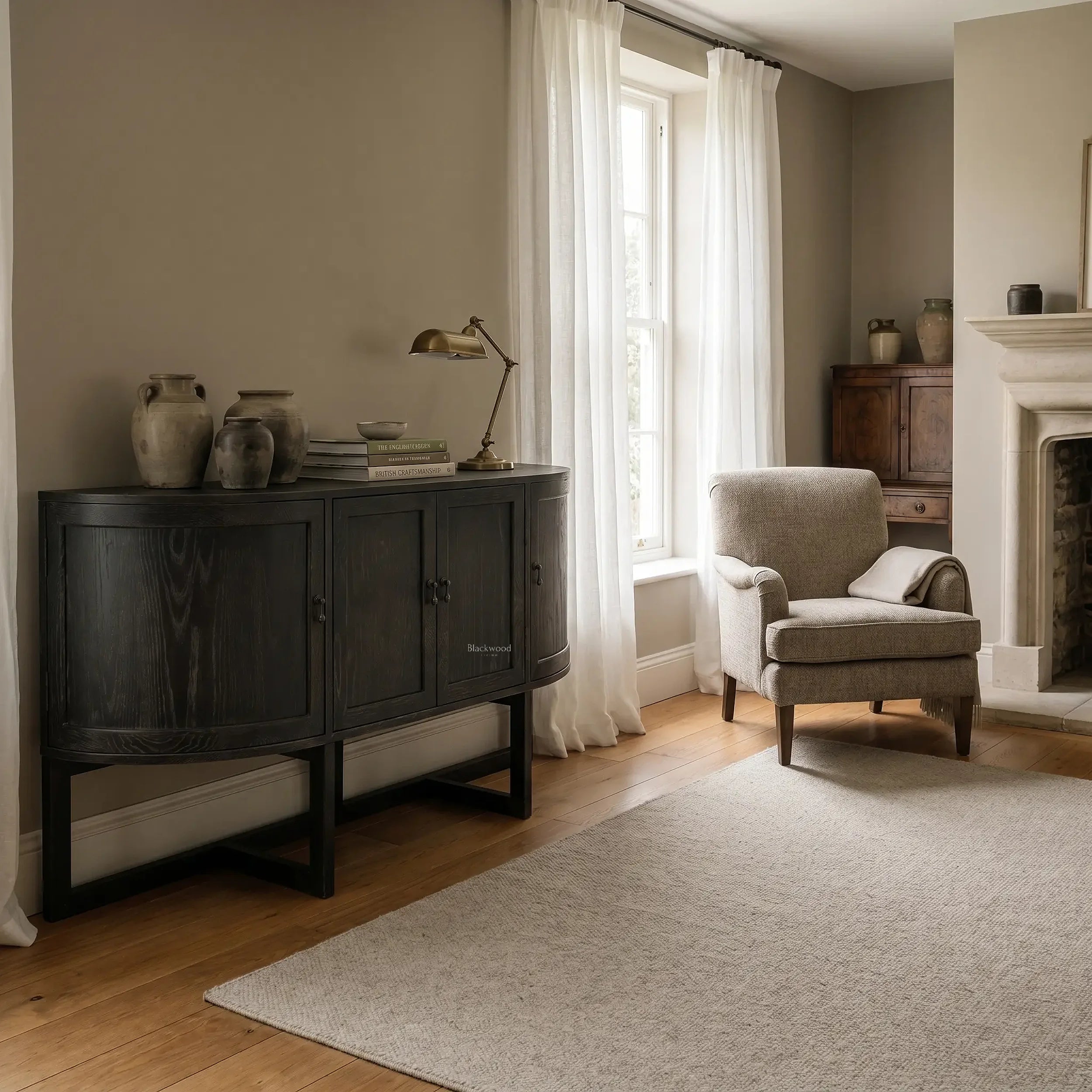 Ravenswood Hall Table in reclaimed oak with a dark finish, curved ends and architectural lines in a cozy living room.