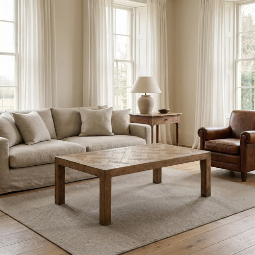 Aldridge Coffee Table in solid reclaimed pine with hand-laid parquet top in a sunlit living room.