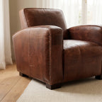 Kingsford Leather Armchair in Vintage Tobacco leather, close-up of studded arm and deep seat.