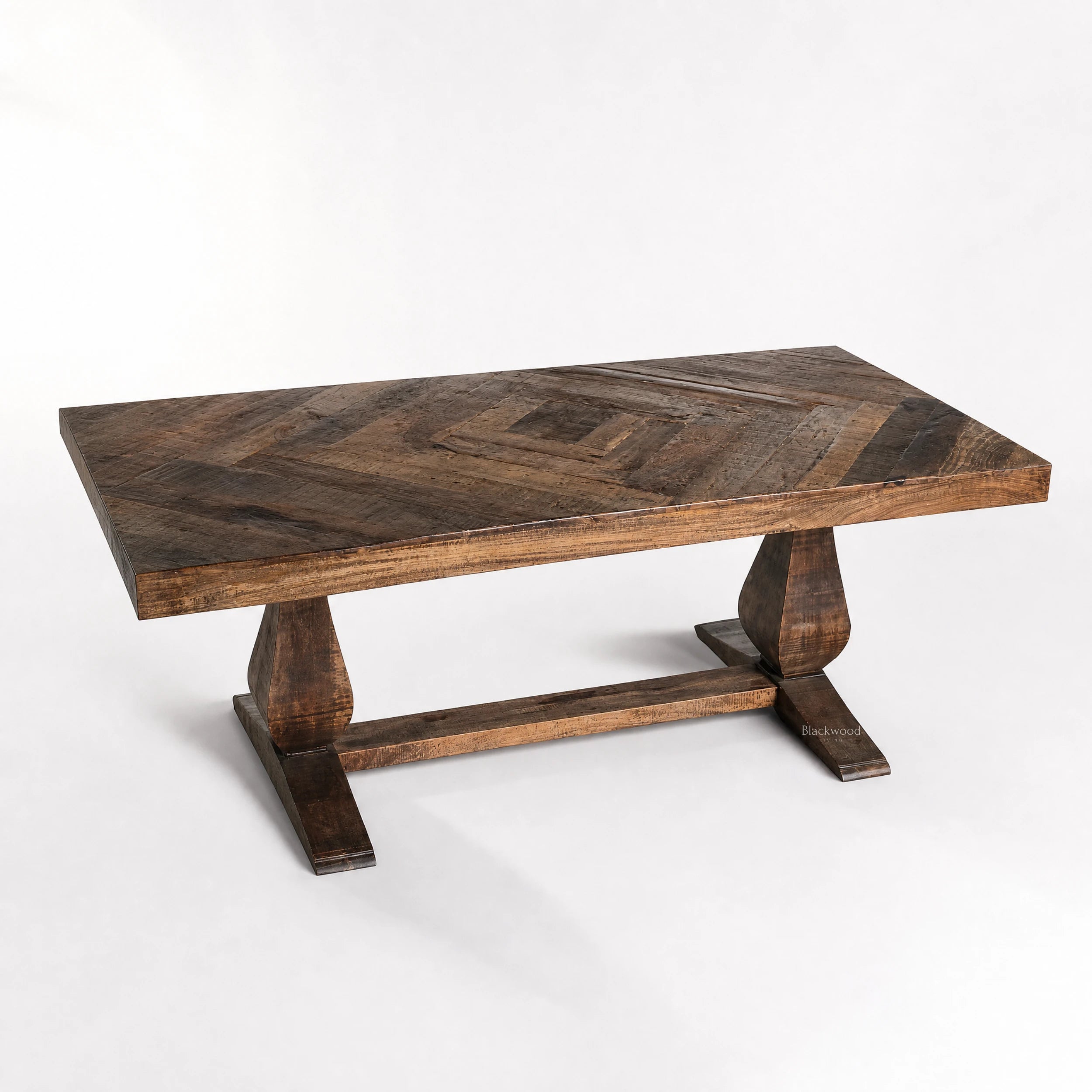 Blackmoor Dining Table in reclaimed mango wood with walnut stain, featuring a parquet top and sturdy trestle legs.
