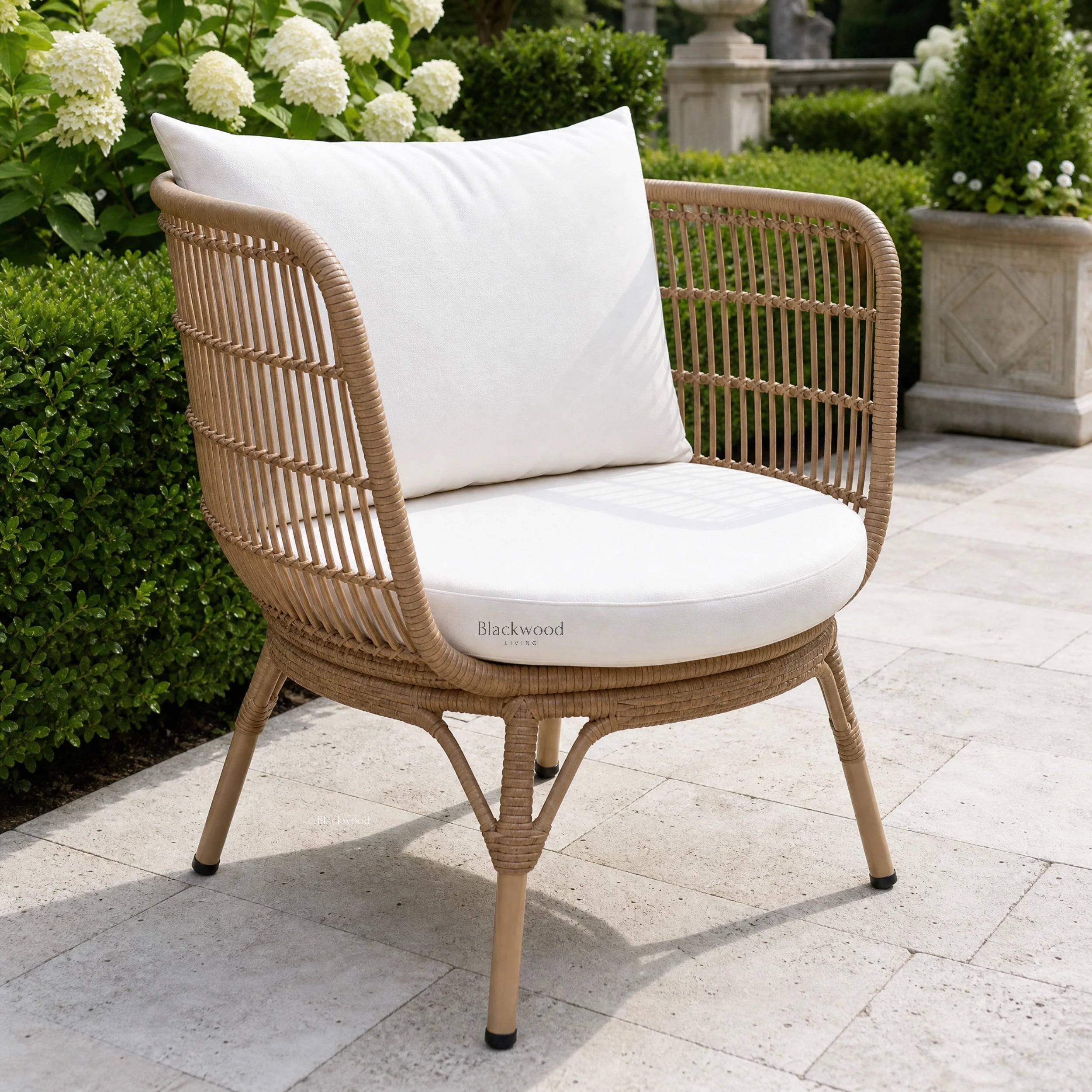 Clifton Outdoor 3-Piece Setting chair with white cushion in a garden, handwoven wicker over aluminum frame.