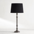 Backthorne Table Lamp with sculptural forged-looking hammered metal stem and black shade.
