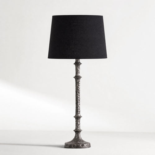 Backthorne Table Lamp with sculptural forged-looking hammered metal stem and black shade.
