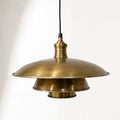 The Mercantile Brass Pendant in antique brass with aged patina, adds warm farmhouse lighting.