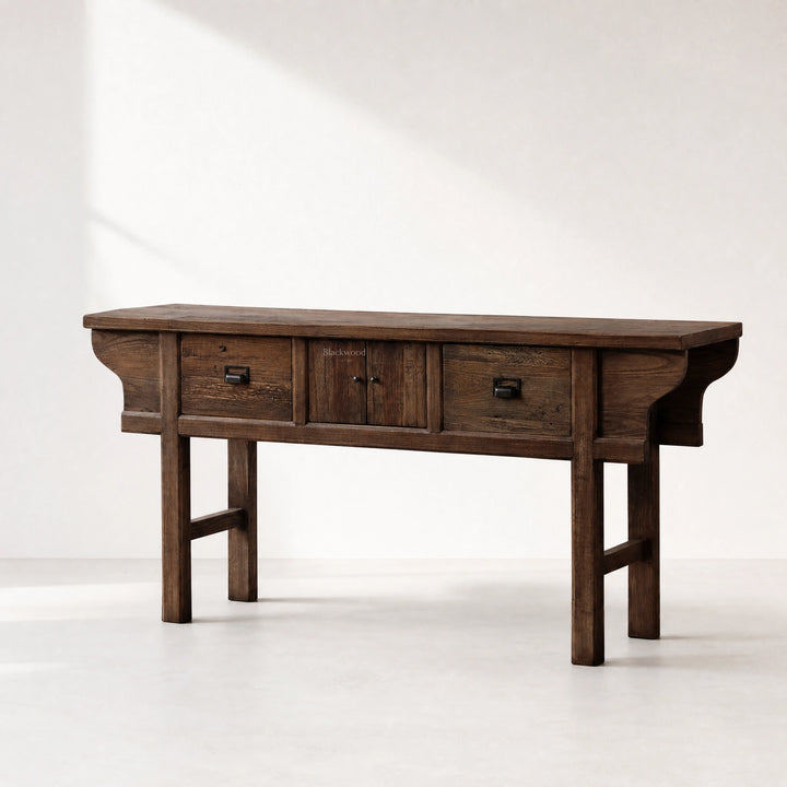 The Raffles Console in aged elm timber, with rich grain and timeless plantation silhouette.
