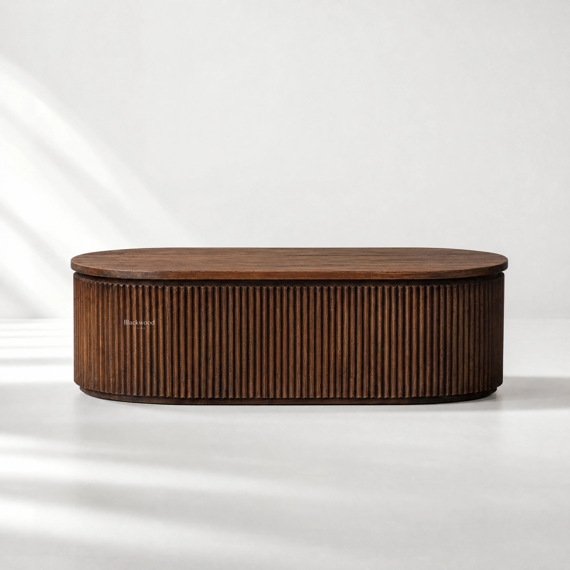 Round Reed Coffee Table in textured old elm with a curved silhouette and deep vertical fluting.