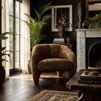 Tsavo Chair in wildlife-pattern chenille sits in a safari-inspired living room with plants and fireplace.
