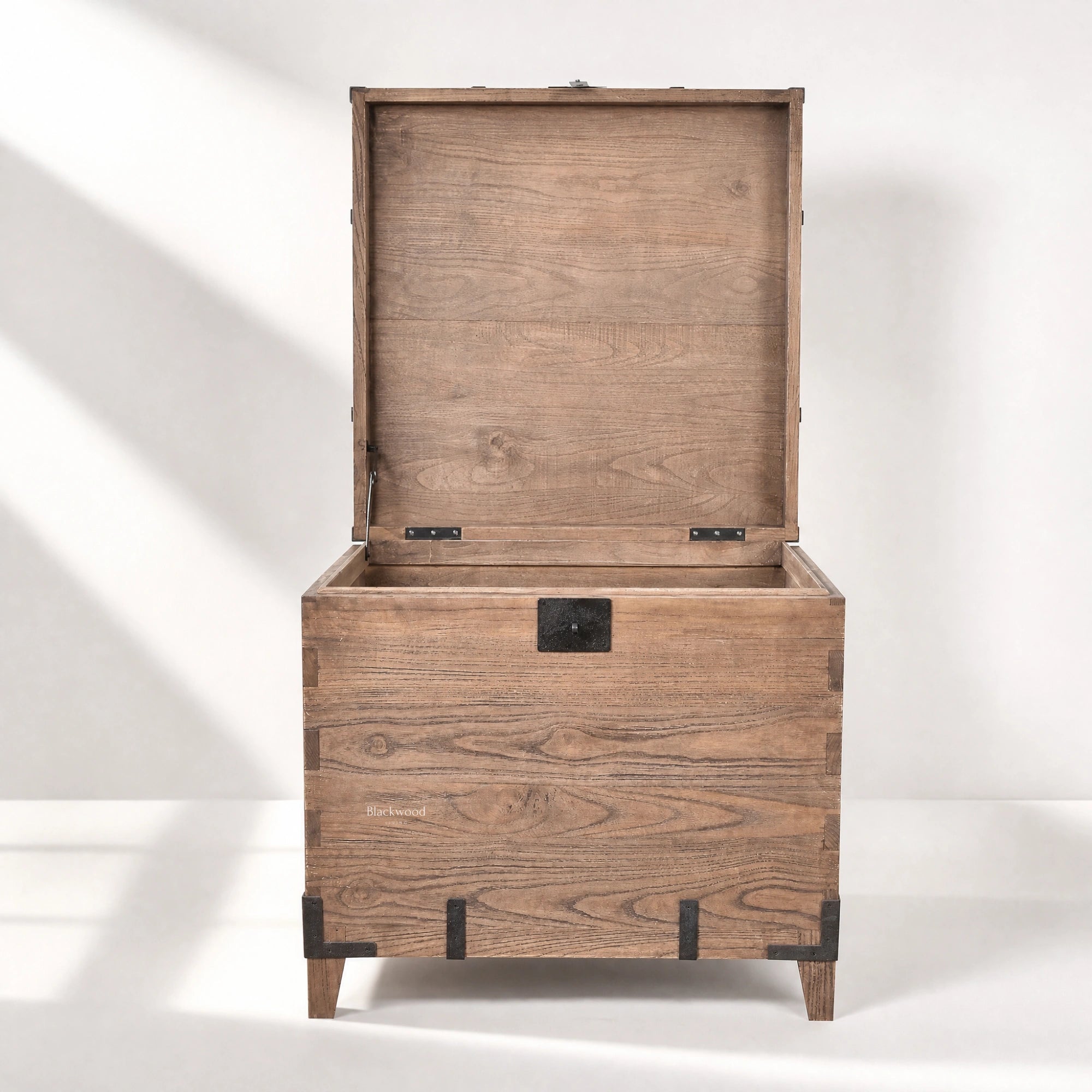 Avignon Trunk Table in reclaimed oak with concealed storage, exposed timber grain, and forged metal detailing.
