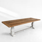 Eastport Dining Table crafted from reclaimed boat wood with teak tones and rustic white trestles.