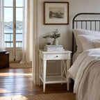 Harbour Bedside Table in white solid poplar timber, Hamptons-inspired, beside bed with books and plant.