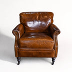 Kensington Leather Club Chair in vintage tobacco leather with nailhead trim and dark wooden legs