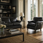 Belgravia 2 Seat Sofa Estate Black leather in a traditional living room with a dark bookcase.
