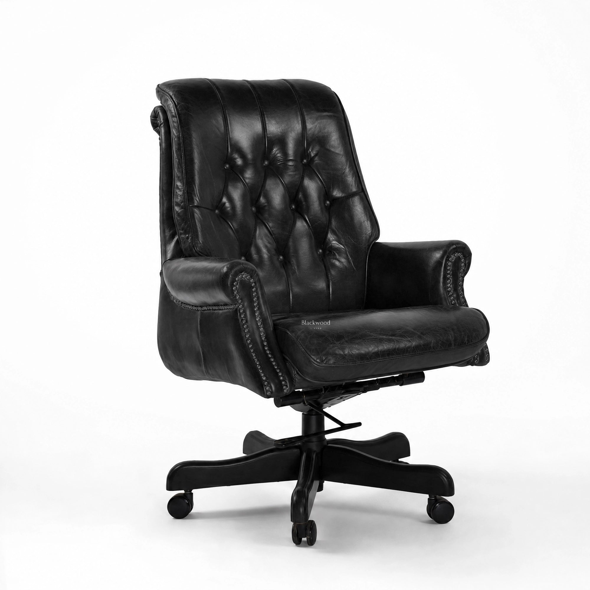 The Merchant Chair Estate Black: tufted black leather executive chair with nailhead trim on a wheeled base.