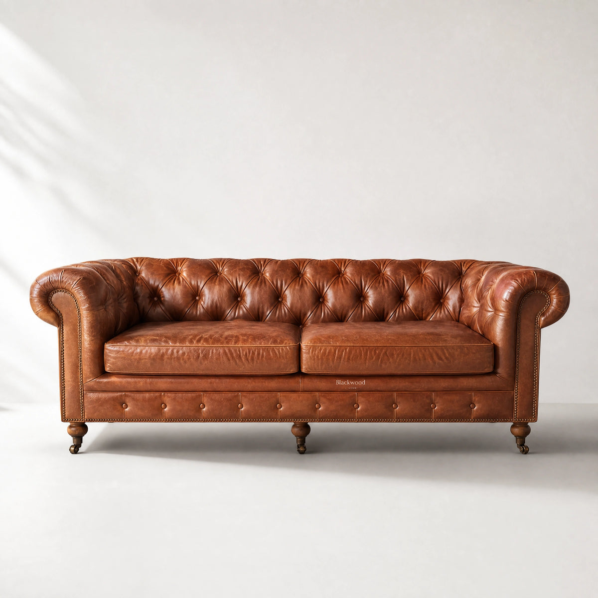 Ashcroft 3 Seat Sofa - Vintage Tan in top-grain cow leather with deep buttoned Chesterfield tufting, rolled arms, brass studs.
