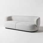Amani Sofa in light gray textured upholstery with a softly curved silhouette.