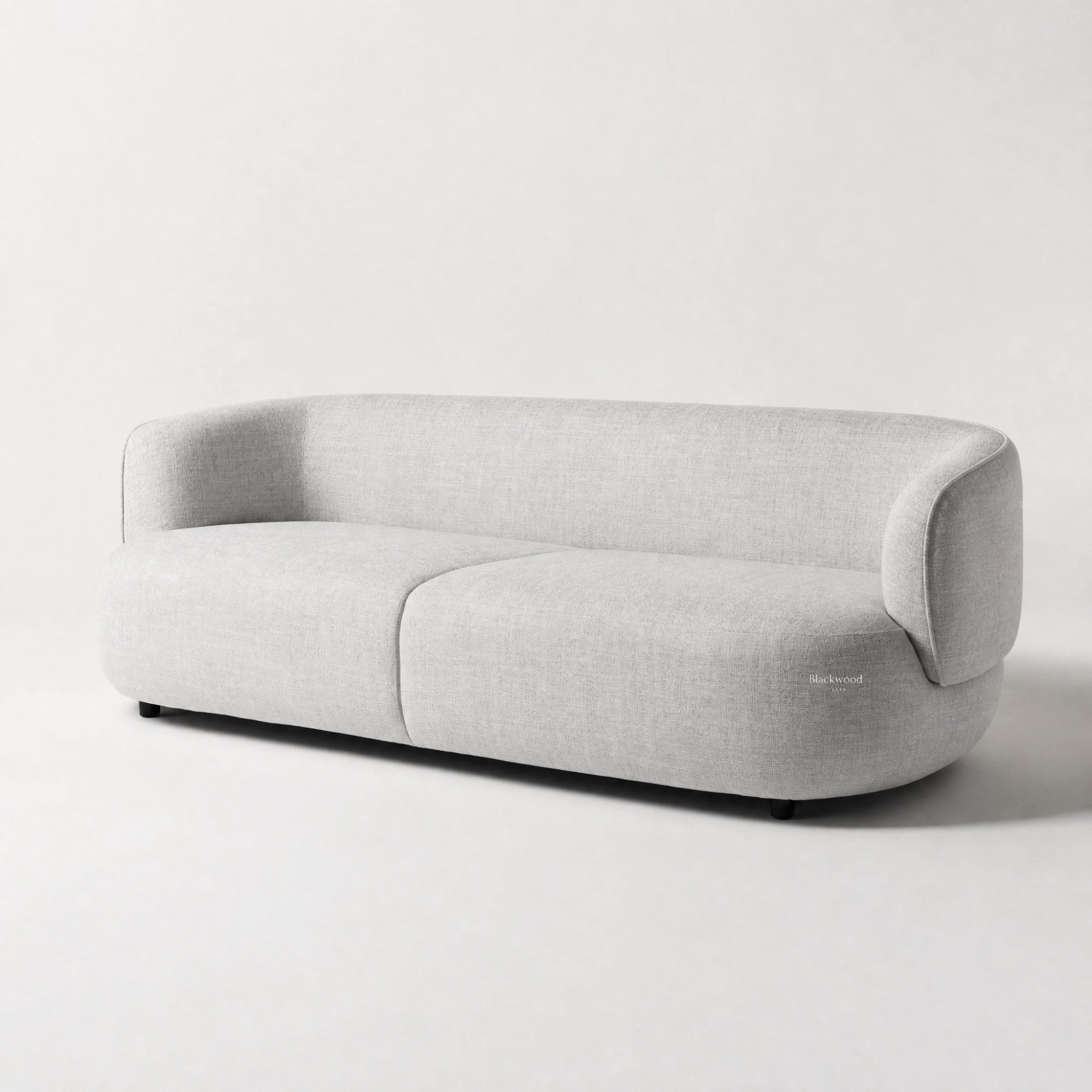 Amani Sofa in light gray textured upholstery with a softly curved silhouette.