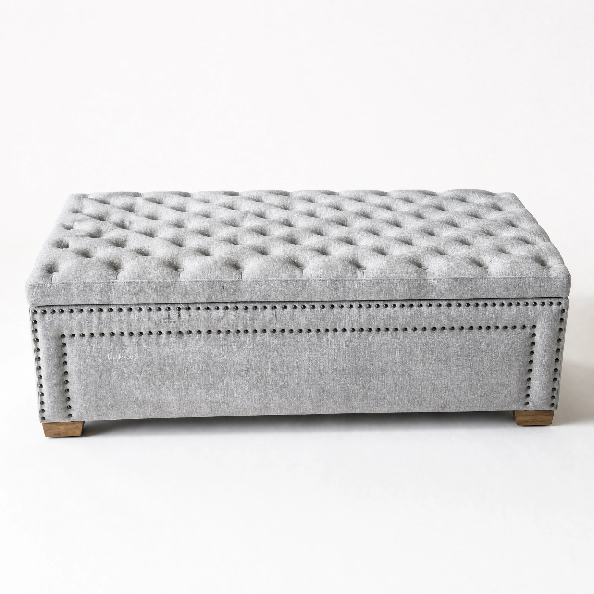 Charlotte Linen Chest: grey linen tufted storage chest with nailhead trim and wooden feet.