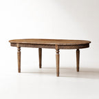 Loire Dining Table in reclaimed elm with weathered finish, carved apron, and turned legs.