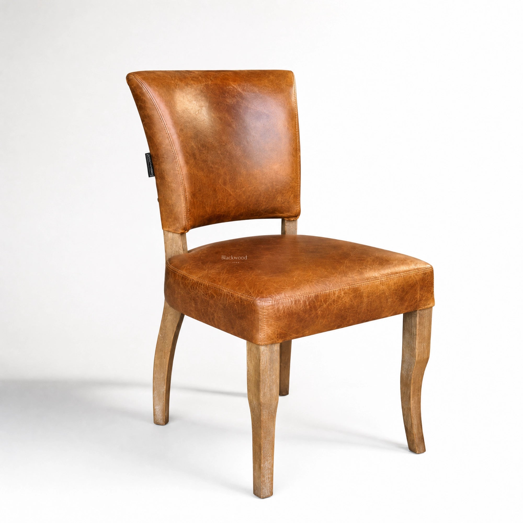 Beaumont Dining Chair in vintage tan leather with solid wood legs.