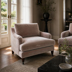 Pembroke Chair - Moonstone in soft gray velvet with a deep seat, plush cushions in a sunlit living room.