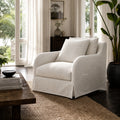 Kingston Occasional Chair with linen-cotton slipcover and timber frame in a serene sunlit living room.