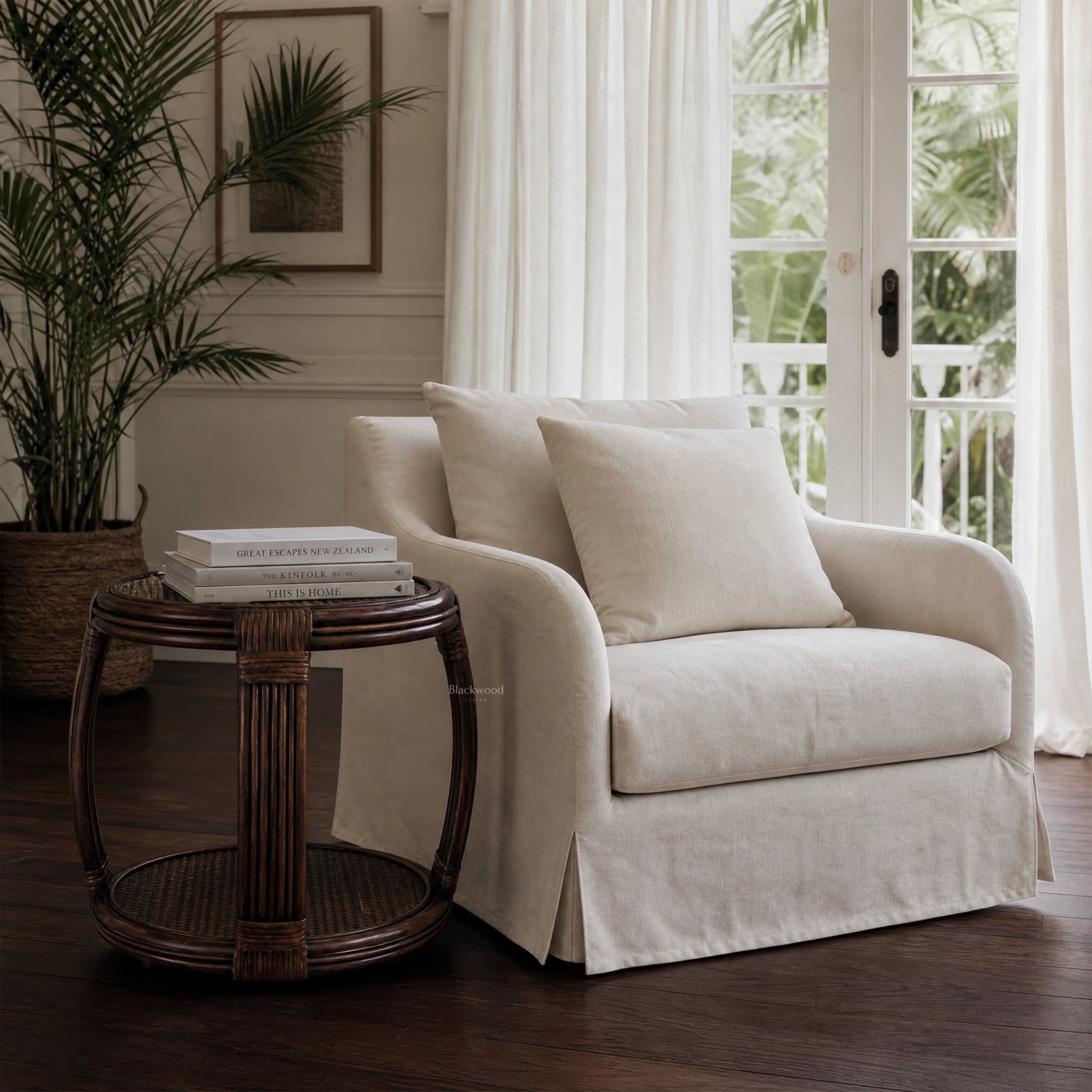 Havana Side Table with handwoven natural rattan and curved silhouette sits beside a cream sofa in a sunlit living room.