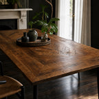 Havana Dining Table 180cm in reclaimed mango wood with walnut finish, grain patterns on a tray with vases and plant.