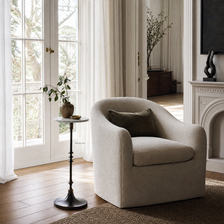 Mayfair Marble Side Table with white marble top and slender black iron pedestal in a bright living room.