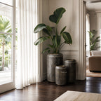 Sumatra Planters Set/3 in aged antique-brass aluminium with softly ribbed surfaces, shown indoors.