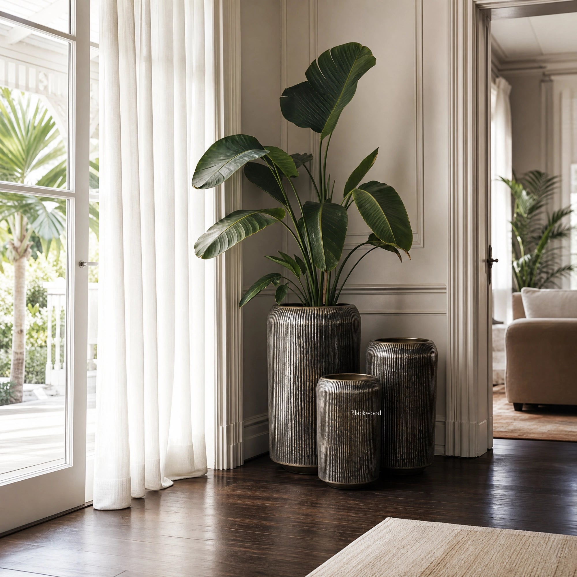 Sumatra Planters Set/3 in aged antique-brass aluminium with softly ribbed surfaces, shown indoors.