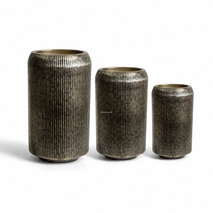 Sumatra Planters Set/3: three ribbed aluminium planters in antique brass finish.