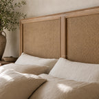 Willow Headboard with Bayur wood frame and woven natural rattan panels in a neutral bedroom.