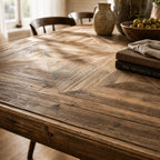 Fairmont Dining Table 250cm in solid old pine with a striking marquetry tabletop, shown in a rustic dining room.