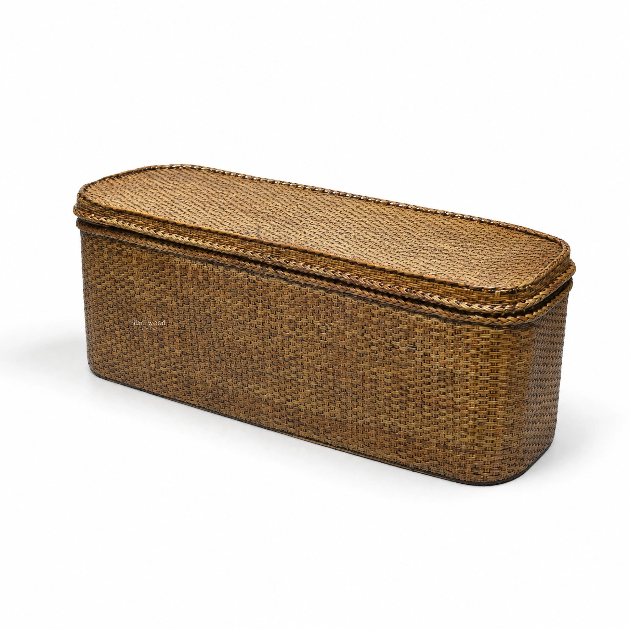 Tamarind Blanket Box in warm woven rattan offers natural storage with plantation-inspired texture.
