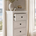 Bayview Tall Dresser - White with cross-panel drawers, topped by vase and stacked books.