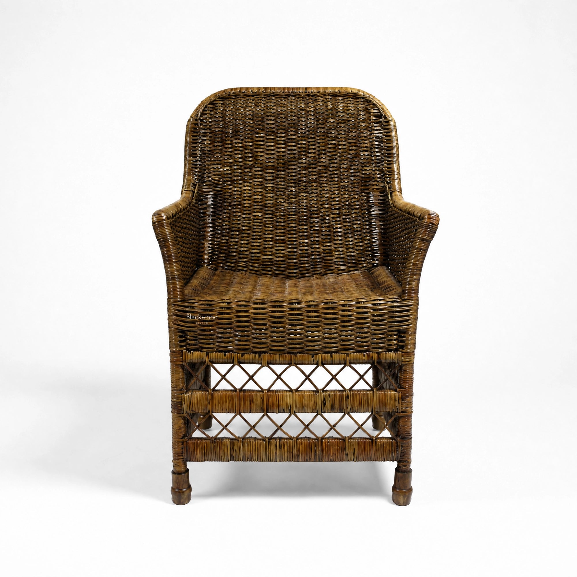 Malacca Accent Chair in woven natural rattan with curved arms and high back, warm plantation style.