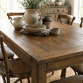 Renwick Extendable Dining Table 1.8m in solid mango wood with warm, rustic grain, set with ceramics and greenery.