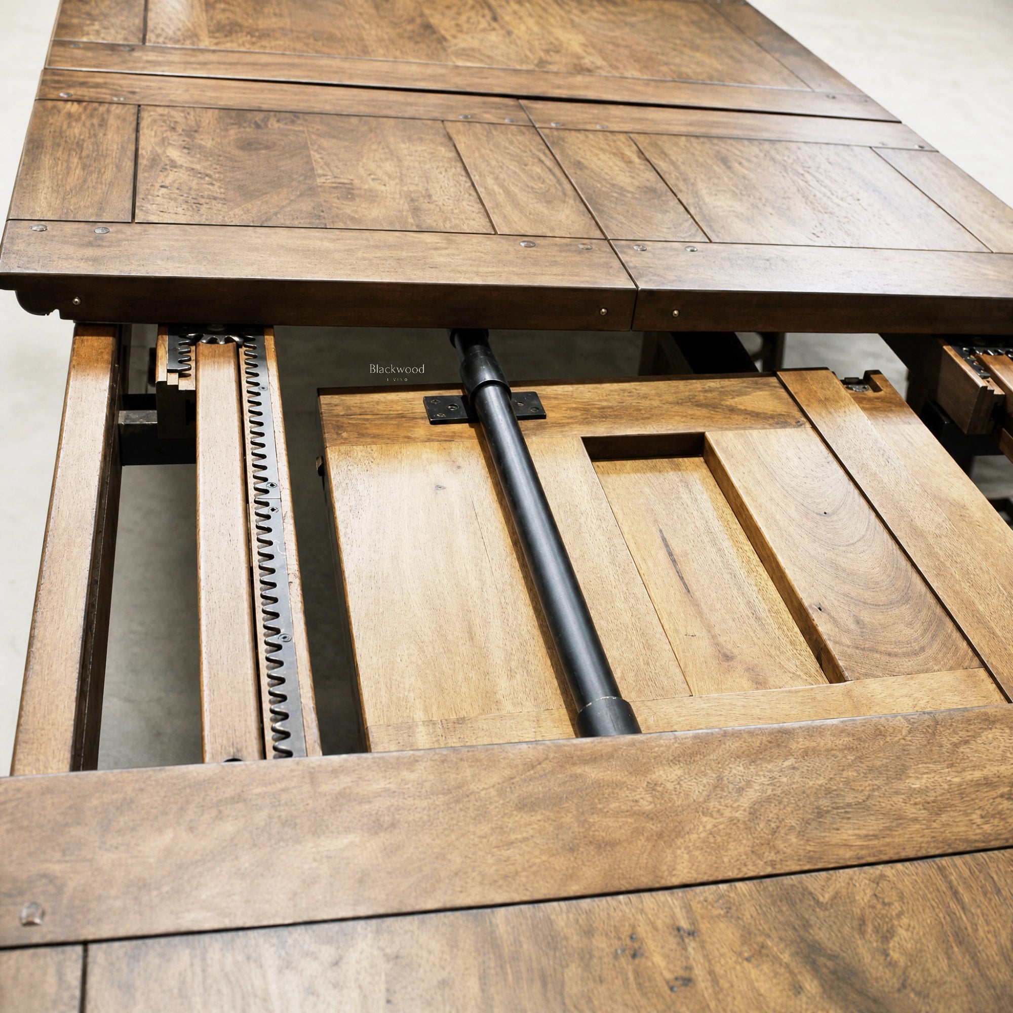Renwick Extendable Dining Table 3.1 in solid mango wood with a paneled top and visible extension mechanism.